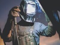 man wearing automatic dark welding helmet